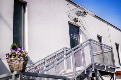 a balcony with a pot of flowers on a building at Penzion Labska Marina in Poděbrady