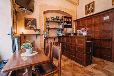 a dining room with a table and a bar at Hotel Dar in Prague