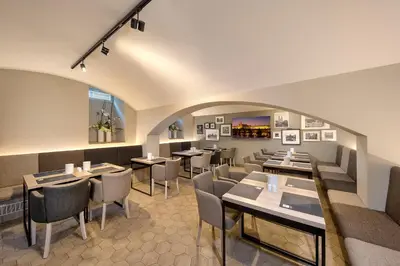 a restaurant with tables and chairs in a room at Avenue Legerova 19 in Prague
