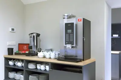 a kitchen with a coffee machine on a shelf at Avenue Legerova 19 in Prague