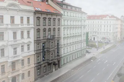 a building on a street next to a street with buildings at Avenue Legerova 19 in Prague