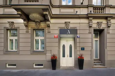 a building with two plants in front of a door at Avenue Legerova 19 in Prague