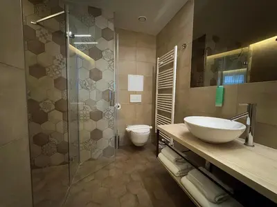 a bathroom with a toilet and a sink and a shower at Avenue Legerova 19 in Prague