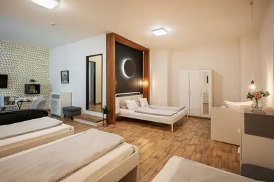 a living room with two beds and a couch at Bohem Prague Hotel in Prague