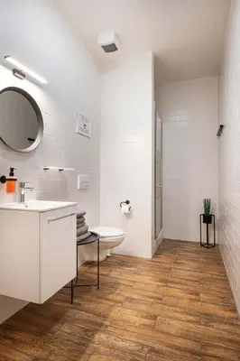 a white bathroom with a sink and a toilet at Bohem Prague Hotel in Prague