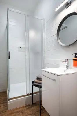 a bathroom with a shower and a sink and a mirror at Bohem Prague Hotel in Prague