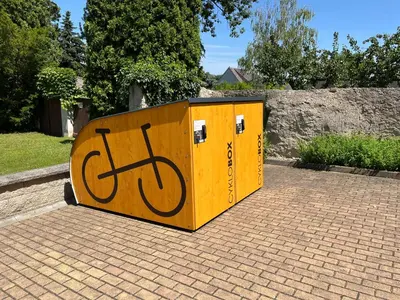 a yellow container with a bike painted on it at Penzion Čokolaterie in Třebenice
