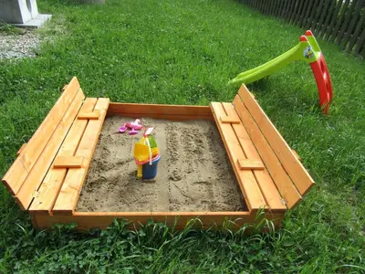 a sandbox in the grass with a toy in it at Rekreacni Dum Brdy in Ohrazenice