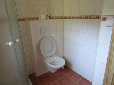 a bathroom with a toilet with the lid up at Rekreacni Dum Brdy in Ohrazenice