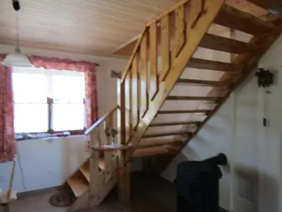 a wooden staircase in a room with a window at Rekreacni Dum Brdy in Ohrazenice