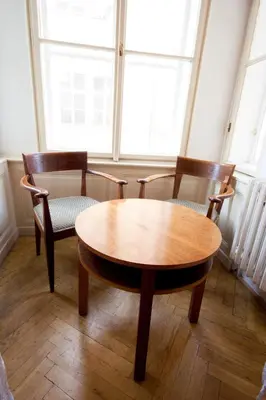 a wooden table and two chairs in front of a window at Hotel U Zlateho jelena in Prague