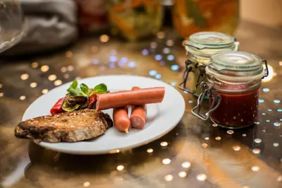 a plate of food with meat and vegetables on a table at Hotel U Zlateho jelena in Prague