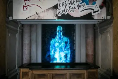 a tv screen with a picture of a man at MeetMe23 in Prague