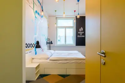 a small bedroom with a bed and a window at MeetMe23 in Prague