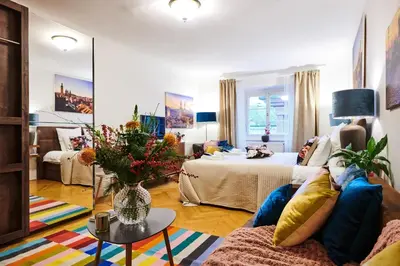 a living room with a couch and a bed at Royal Route Residence in Prague