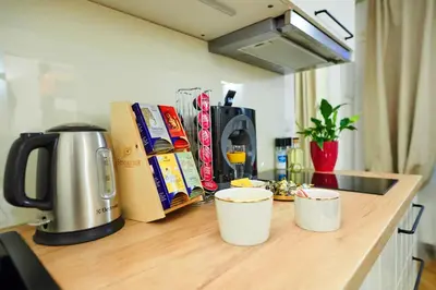a kitchen counter with two coffee cups on a counter top at Royal Route Residence in Prague