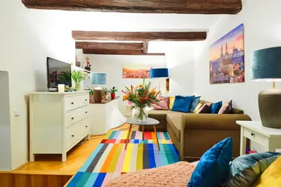 a living room with a couch and a table at Royal Route Residence in Prague