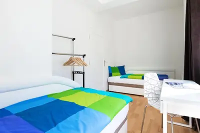a bedroom with two beds and a table at Hanan's Benedikt in Prague