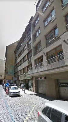 a street with cars parked in front of a building at Hanan's Benedikt in Prague