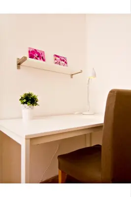 a white desk with a plant on top of it at Apartments with 2 Bathrooms in Prague