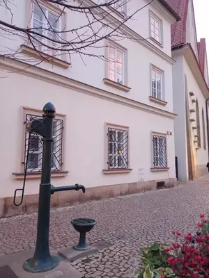 a pole on a street in front of a building at Betlem Prague Apartments in Prague