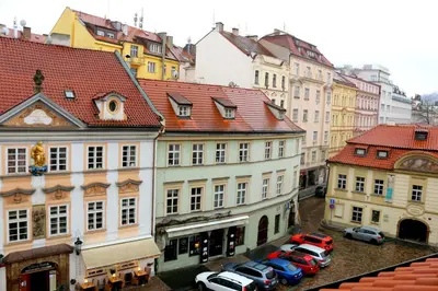 a group of buildings with cars parked in a parking lot at Betlem Prague Apartments in Prague
