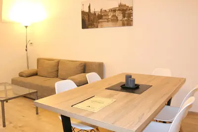 a living room with a wooden table and a couch at Betlem Prague Apartments in Prague