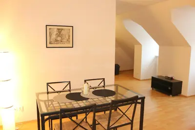a dining room with a glass table and chairs at Betlem Prague Apartments in Prague