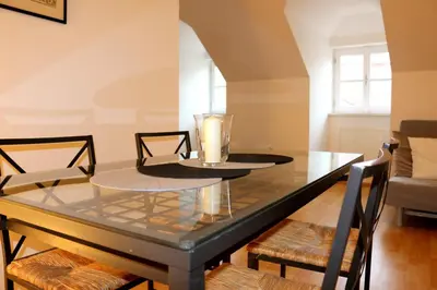 a dining room table with a glass top at Betlem Prague Apartments in Prague