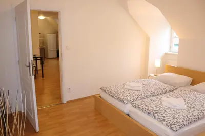 a bedroom with a bed with two towels on it at Betlem Prague Apartments in Prague