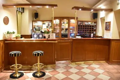 a bar with a counter and two stools at Arbes in Prague