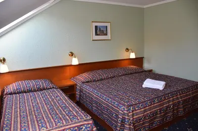 a room with two beds in a hotel room at Arbes in Prague