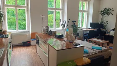 a kitchen with a counter in a room with windows at Park View - a digital Nomad's dream in Prague