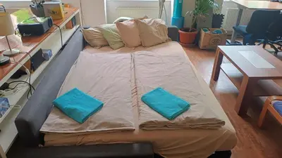 a large bed with two pillows on it in a room at Park View - a digital Nomad's dream in Prague