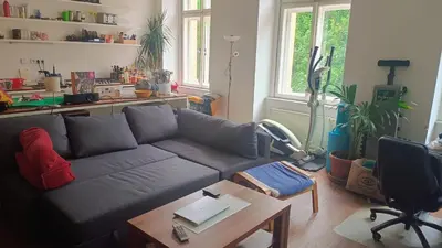 a living room with a couch and a table at Park View - a digital Nomad's dream in Prague