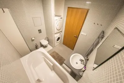 a bathroom with a tub and a sink and a toilet at Apartment Korunni Dvur 130m2, 2 Free Parkings in Prague