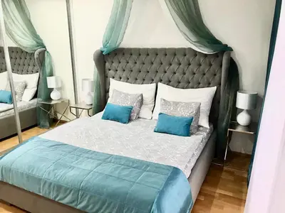 a bedroom with a blue and white bed with blue pillows at Apartment Korunni Dvur 130m2, 2 Free Parkings in Prague