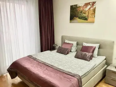 a living room with a couch and a table at Apartment Korunni Dvur 130m2, 2 Free Parkings in Prague