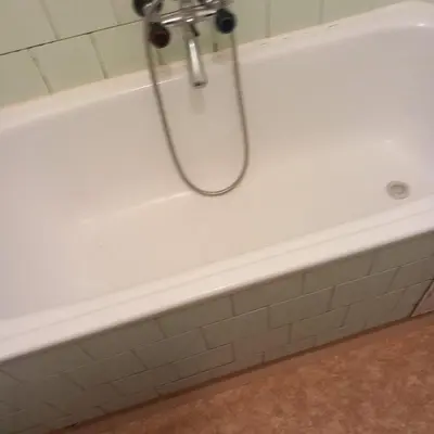 a white bath tub with a shower head at flat 18 minutes from Vaclavske namesti in Prague