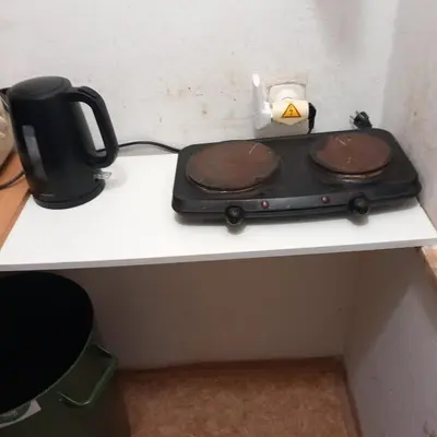 a table with a stove with two pans on it at flat 18 minutes from Vaclavske namesti in Prague