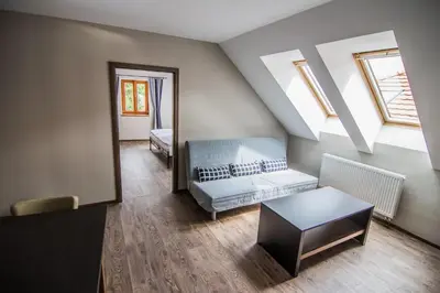 a living room with a couch and a table at Pension Viktorin in Poděbrady