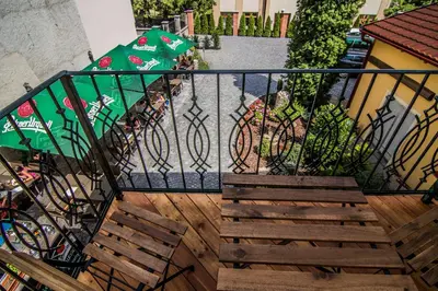 a staircase with a fence and a green umbrella at Pension Viktorin in Poděbrady