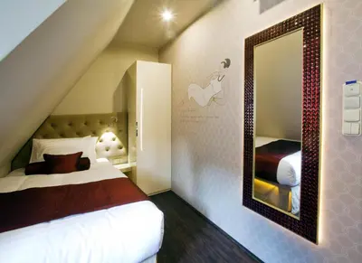 a bedroom with a bed and a mirror at Design Hotel Jewel Prague in Prague