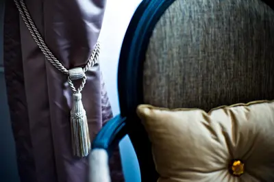 a necklace and a pillow on a chair at Design Hotel Jewel Prague in Prague