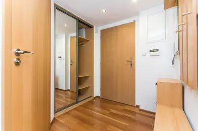 a hallway with a door and a mirror at Attic Apartment by Wenceslas Square in Prague