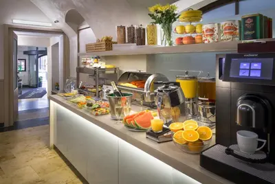 a breakfast counter with fruits and juice on it at Clementin in Prague