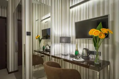 a room with a table with flowers on it at Clementin in Prague