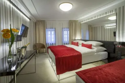 a hotel room with a bed and a mirror at Clementin in Prague