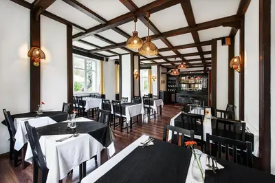 a dining room with tables and chairs in a restaurant at Marie - Luisa in Prague