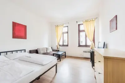 a kitchen and dining room with a table and chairs at Family Apartments Praha 6 in Prague